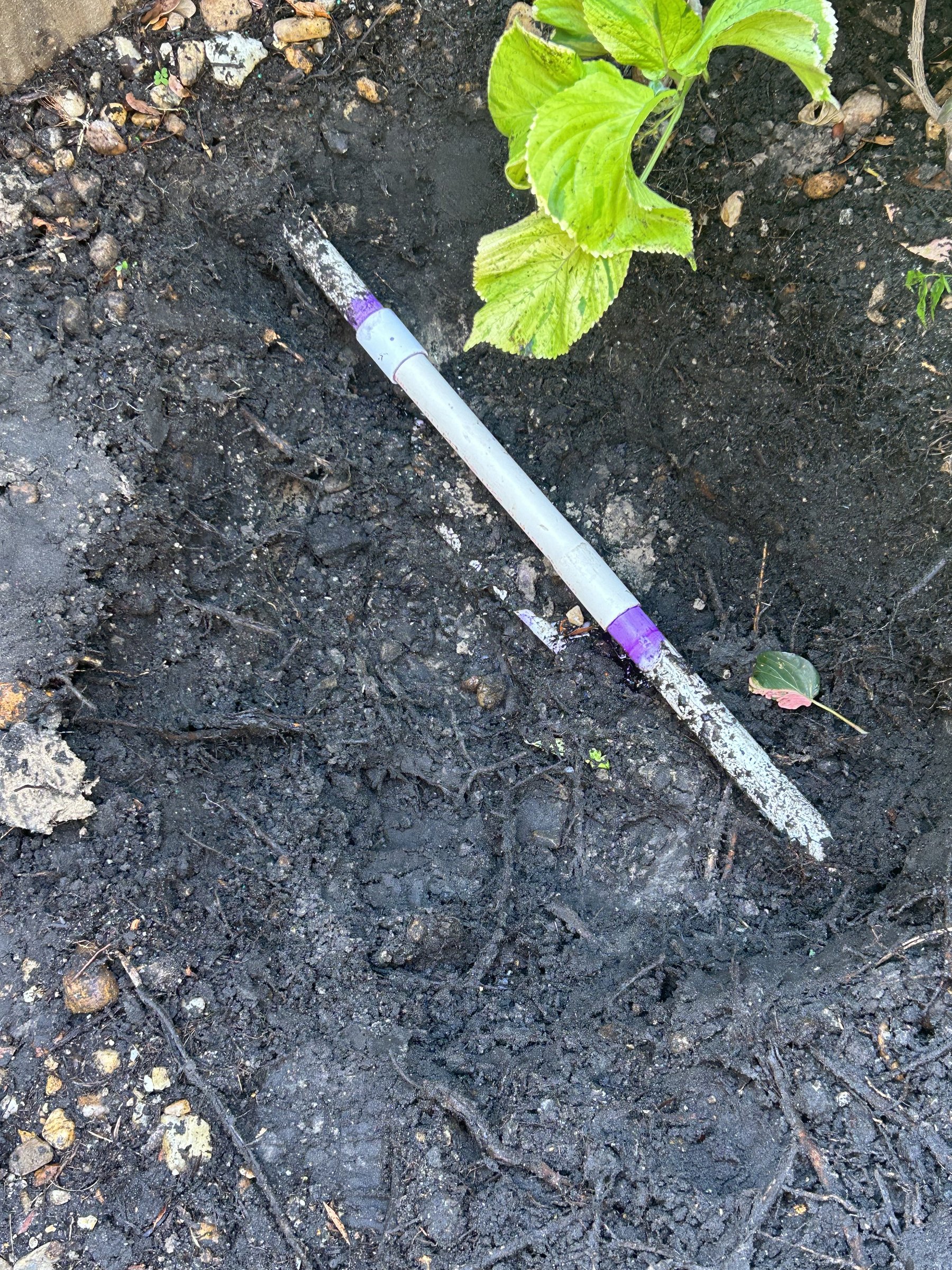 PVC irrigation pipe joints in a shallow trench ready for lasting water lines